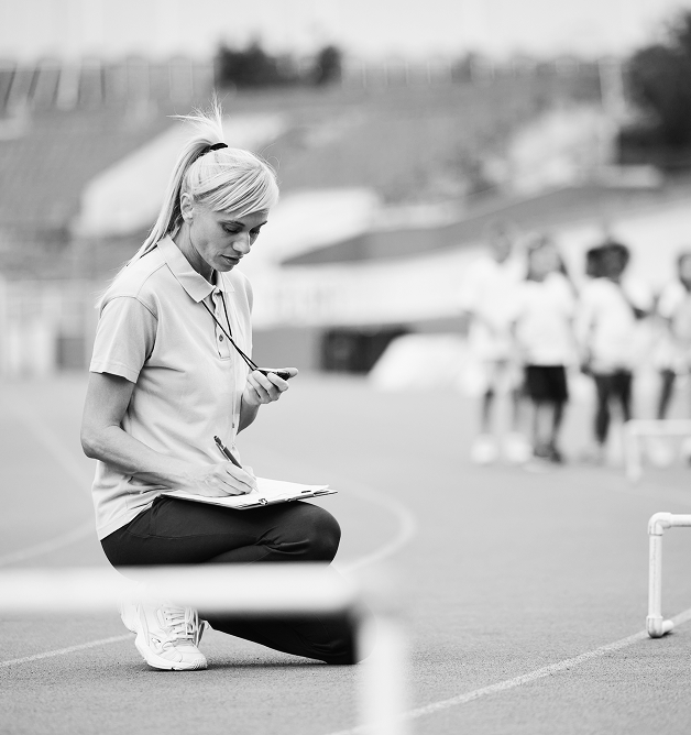 Track coach writing down times 